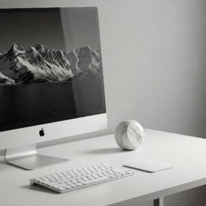 "Clean and minimalist staged work desk with essential items like a monitor, keyboard, and a single decorative element."