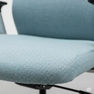Close-up of the fabric texture of a desk chair light blue, highlighting its durable weave.