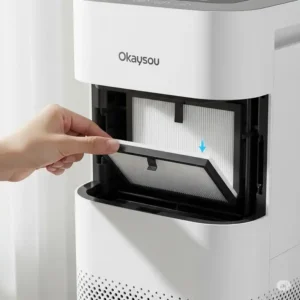 Hand replacing a filter in an Okaysou air purifier, demonstrating easy maintenance for optimal performance.