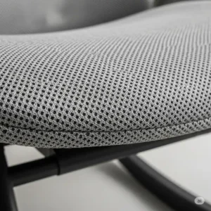Close-up shot of the breathable mesh fabric on an office chair rocker, highlighting material quality.