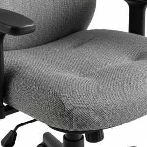 A detailed image of the thick, high-density foam cushioning on a comfortable desk chair for large people, showing the breathable fabric.