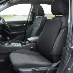 Image of the versatile portable desk chair back support cushion being used comfortably on a car seat for travel and driving support.