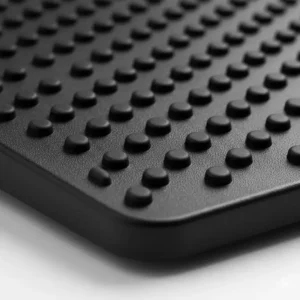 Close-up view of the non-slip massage surface texture on an adjustable footrest.