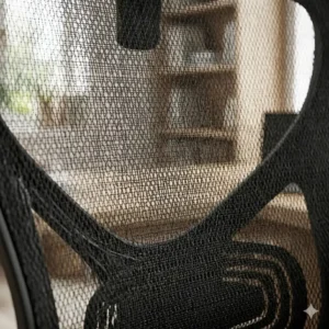Close-up view of the breathable fabric material on a high-back mesh office chair.