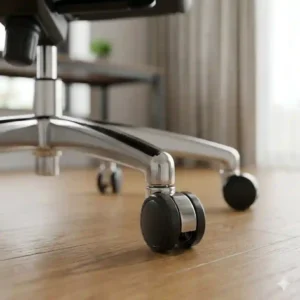 Heavy-duty chrome base and smooth-rolling caster wheels of a 360-degree swivel executive leather office chair.